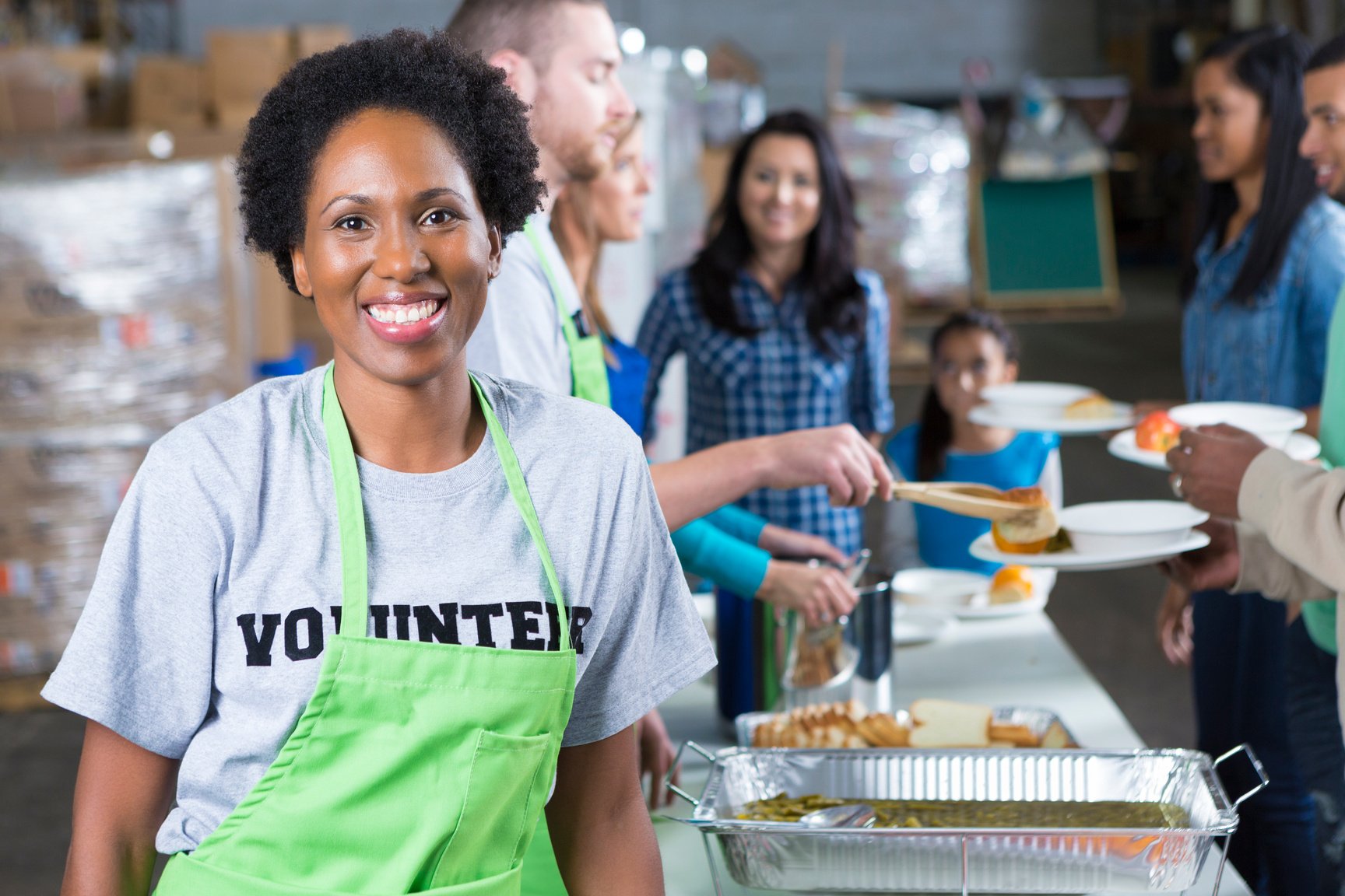 African American woman volunteering at community soup kitchen